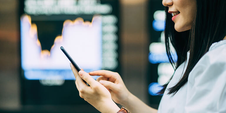 Close up of a woman scrolling on her smart phone