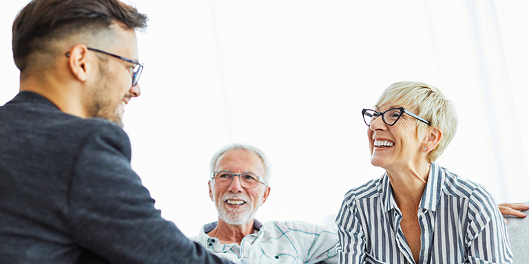 Couple speaking with a financial representative