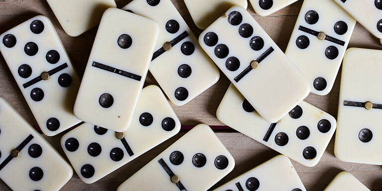 Close up of a set of dominoes on a wooden table 
