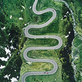 Arial view of a winding road passing through a mountainous area 