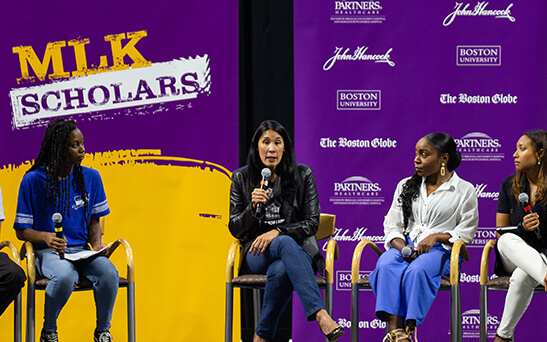 A group of MLK Scholars on stage speaking about their experiences as a scholar
