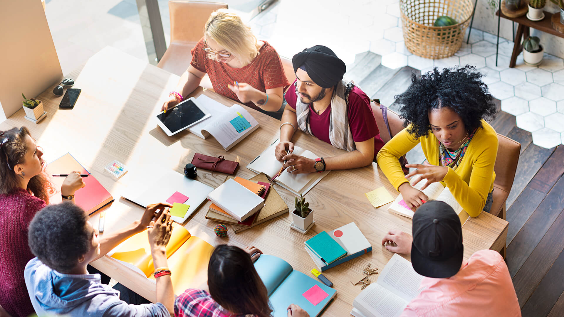 A group of co-workers discussing work topics around a table 