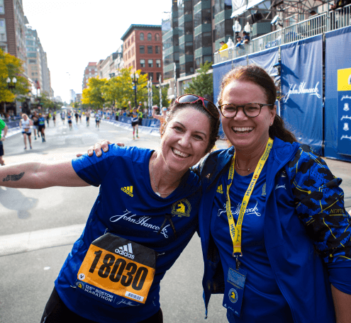 Marianne Harrison and a John Hancock runner at the 125th Boston Marathon