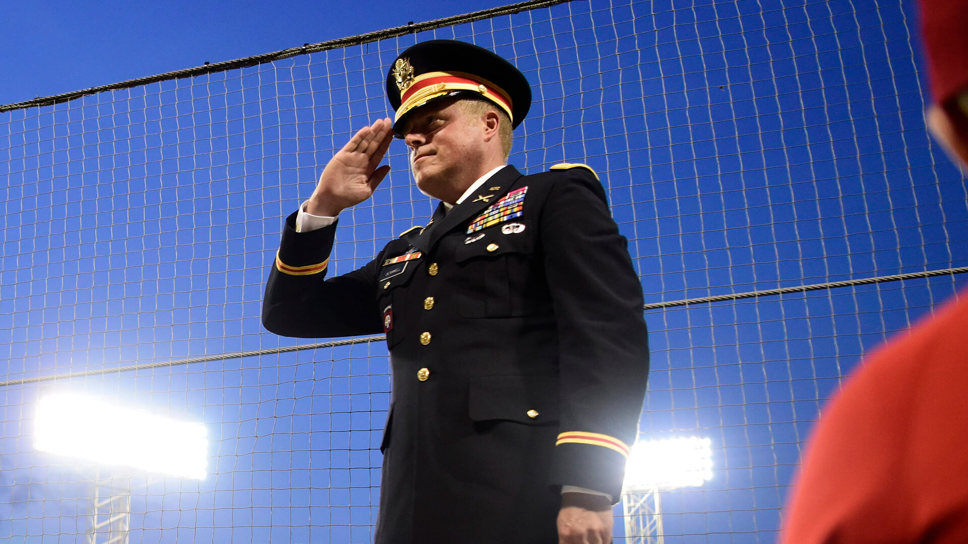 An American military service member saluting during a Red Sox game at Fenway Park in Boston, Massachusetts, USA 