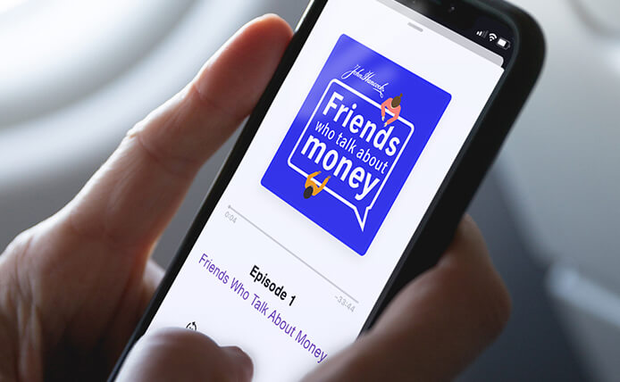 Closeup of someone holding a smart phone that is playing an episode of the Friends Who Talk About Money podcast