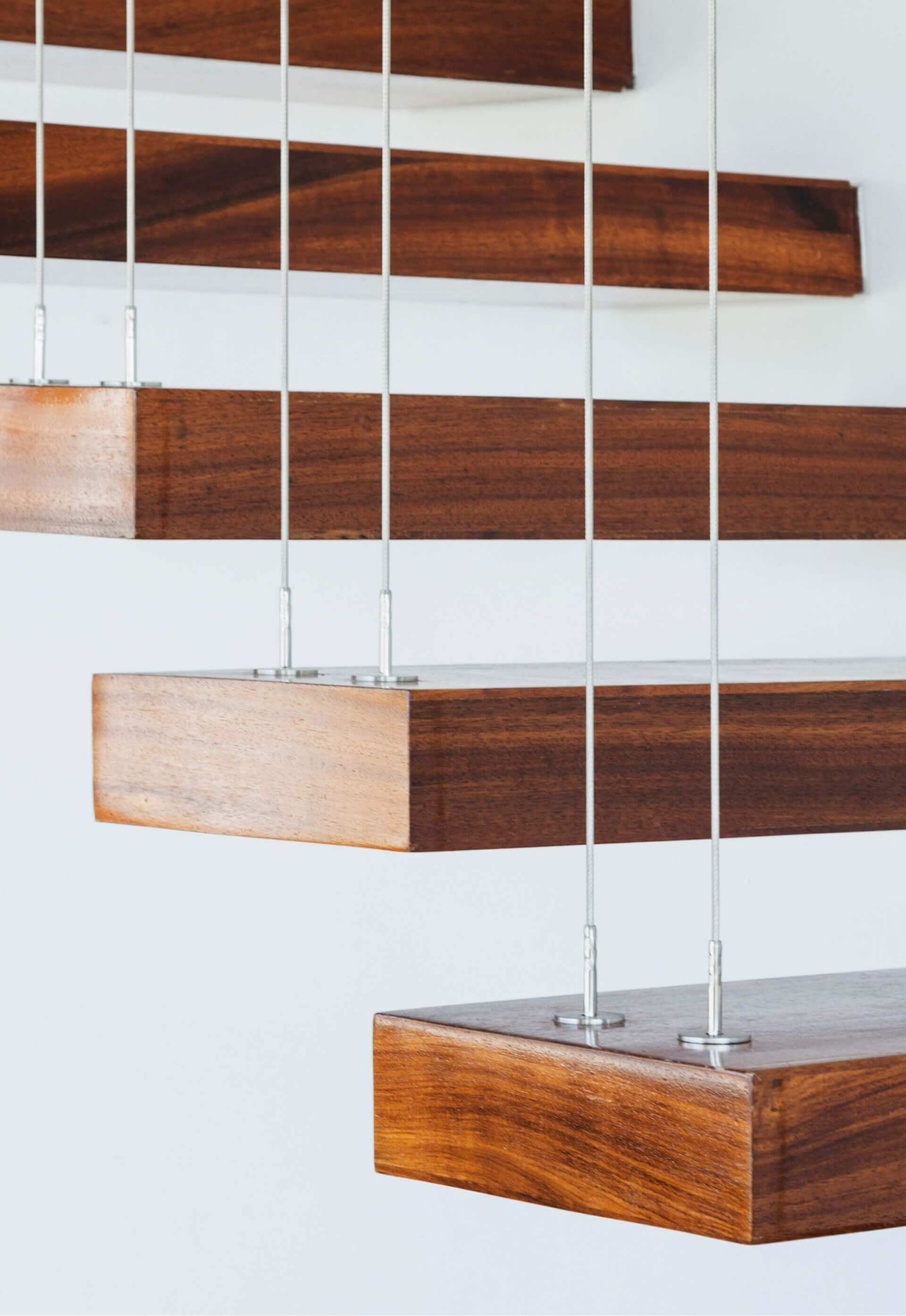 Floating wooden stairs being suspended by wires