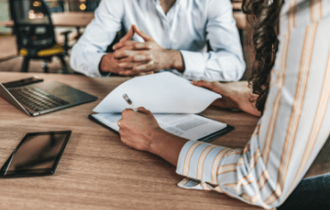 Two people reviewing a contract