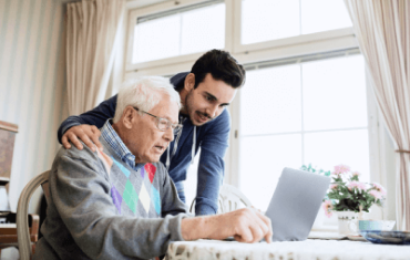 Assisted living resident getting some help with his laptop