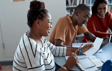 Three people studying in a library