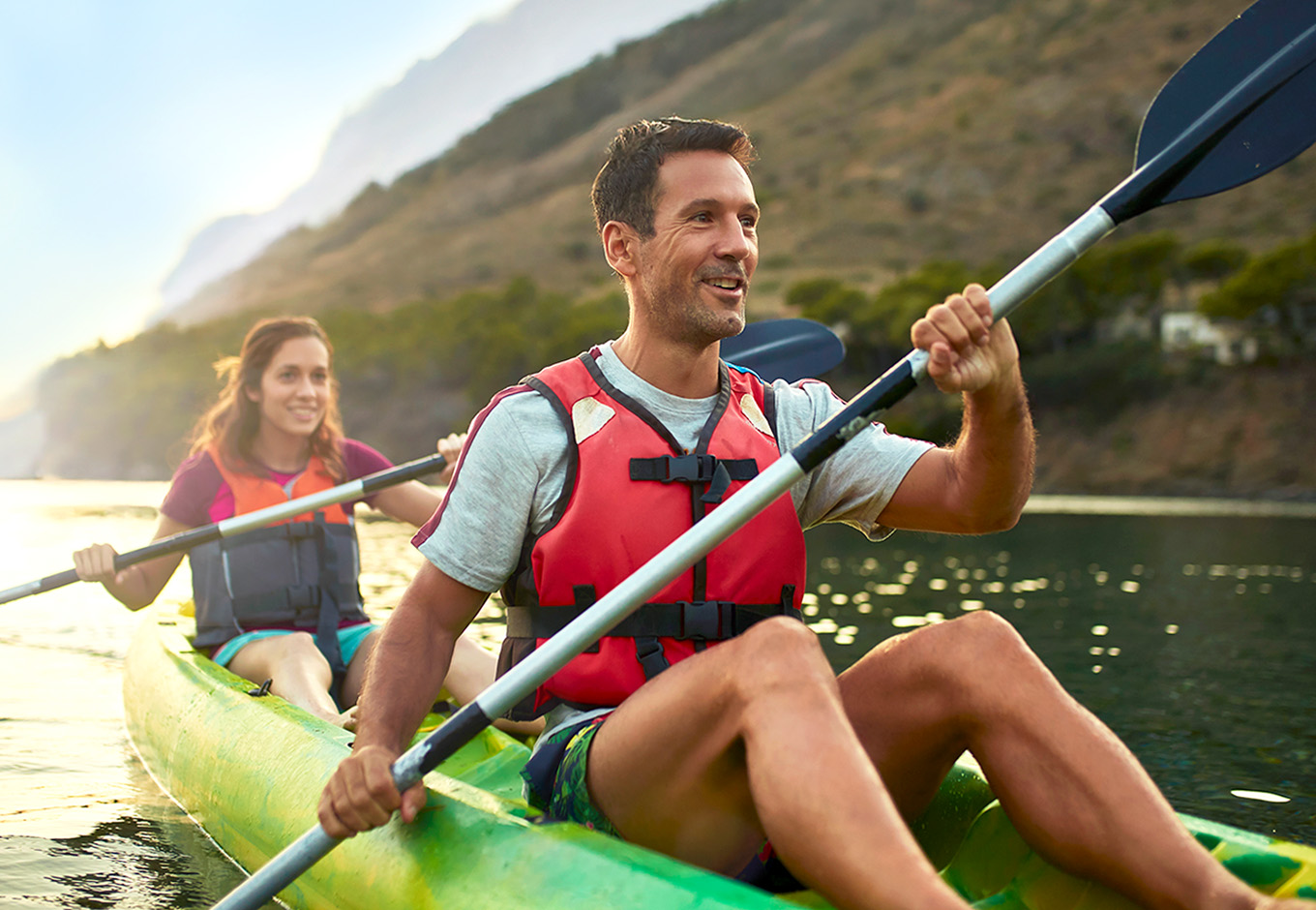 Secure your family's future with life insurance that protects what matters most. A couple kayaking on a peaceful lake reflects shared adventures and lifelong security. Get coverage that grows with your family.