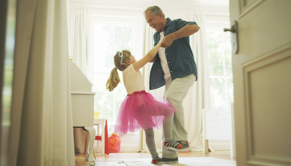 grandfather dancing with his granddaughter